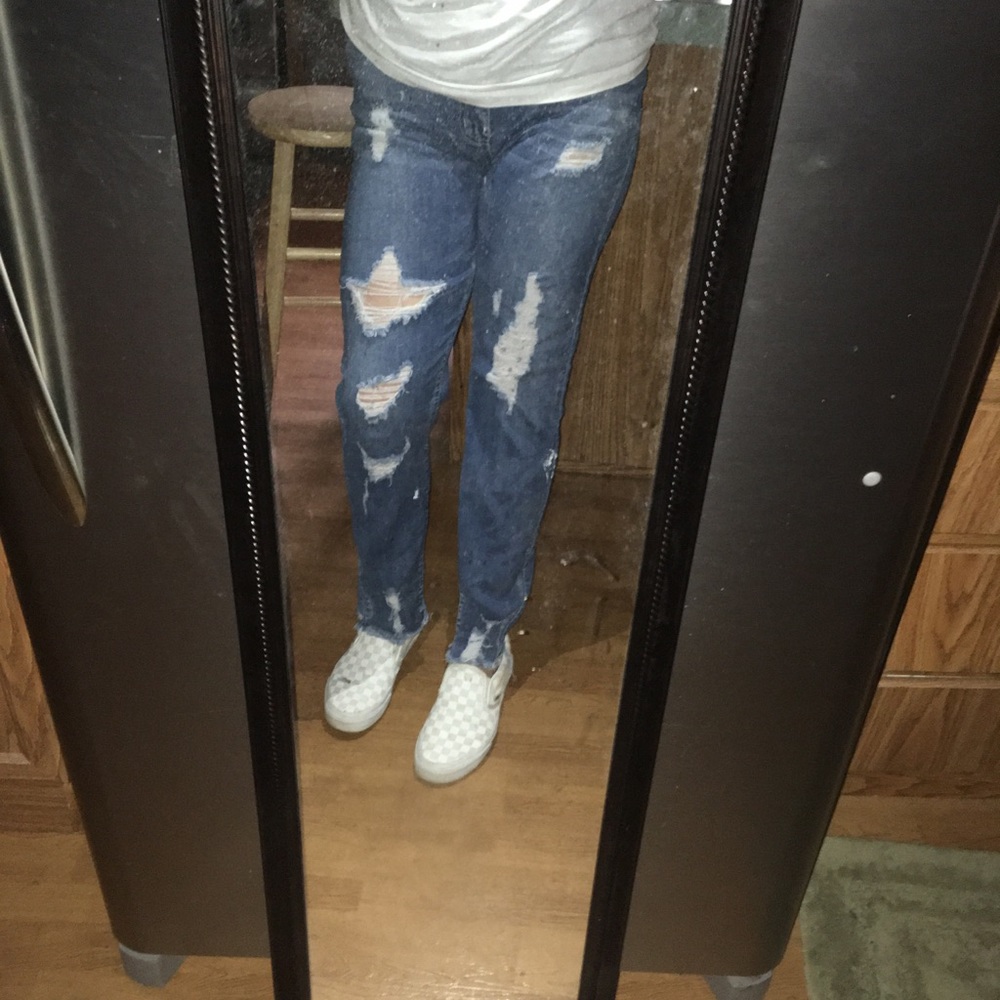 Womens skinny distressed jeans with some paint marks on one leg